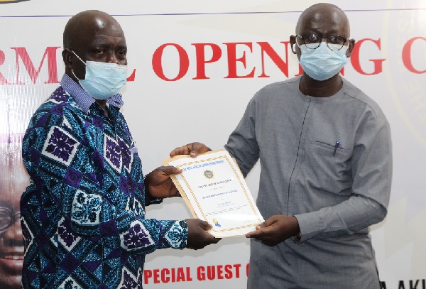 Prof. Kwasi Opoku-Amankwa (right), the Director-General of the Ghana Education Service, presenting a certificate to Mr Emmanuel Manukure Ansah (left), on behalf of Ms Afua Manukure Ansah. Picture: ESTHER ADJEI